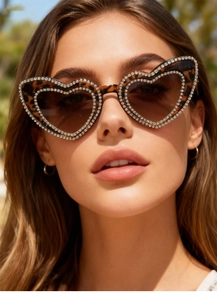 Detail of heart-shaped leopard print sunglasses with double row crystal rhinestones