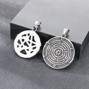 Detailed view of silver Hecate pendant with labyrinth engraving and pentagram symbols