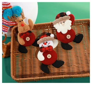 Detailed view of plush Santa, reindeer and snowman ornaments with plaid bows on tray