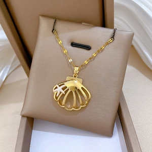 Detailed macro shot of a gold shell pendant with a white starfish on a jewelry display