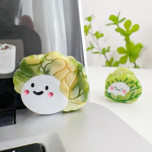 Cute cabbage-shaped acetate hair claw clip with smiling face in vibrant green and white