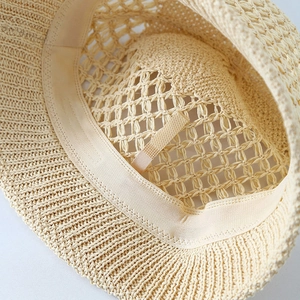 Detailed macro view of the breathable straw hat interior with adjustable sweatband
