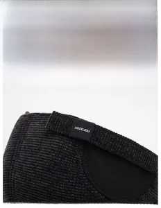 Close-up of adjustable strap with metal buckle on a warm winter earflap baseball cap