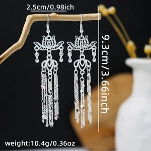 Macro detail of silver bohemian tassel earrings showing 9.3cm length and hollow carvings