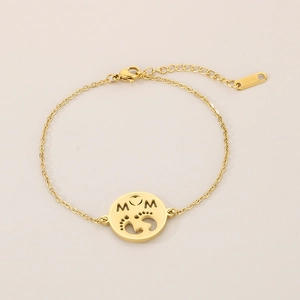 Detail of gold MOM pendant bracelet with tiny baby footprints and lobster clasp