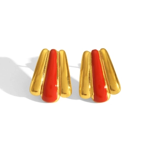 Detail of red enamel fan-shaped earrings with golden base and striped metal texture