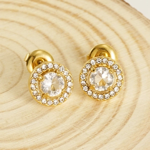Double-layer gold halo earrings with round clear crystal on natural wood background