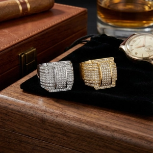 Luxury gold and silver men's star rings with cubic zirconia on black velvet and cigars