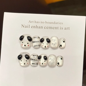 Handmade press-on nails with 3D panda heads and black bows on pearly white base