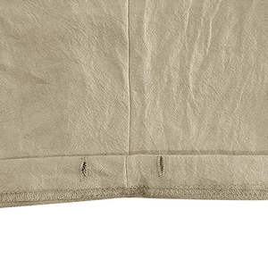 Detailed macro view of khaki linen fabric texture with dual buttonhole and seam stitching