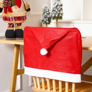 Detail of red Santa hat chair cover made of soft non-woven fabric for Christmas table decor