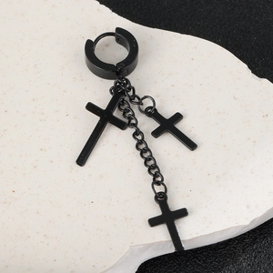 Macro detail of black matte stainless steel earrings with cross chain tassels and punk style