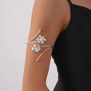 Detailed view of silver flower arm cuff with sparkling rhinestones on spiral metal band