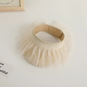 Detail of cream straw sun hat featuring elegant lace trimming and pearl mesh accents
