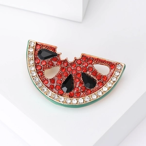 Fashionable watermelon slice brooch with red rhinestones and green enamel on white background