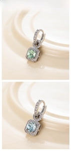 Detail of square zircon drop earrings with pave crystals and silver hoop clasps