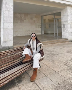 Classic brown suede snow boots with warm lamb wool lining in a cozy outdoor setting