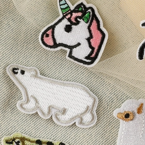 Variety of colorful cartoon animal embroidered patches including unicorn and polar bear