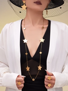 Detailed set of 18k gold plated star earrings, necklace and rings on professional model
