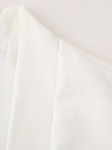 Detail shot of white padded vest showing refined fiber texture and stitching quality