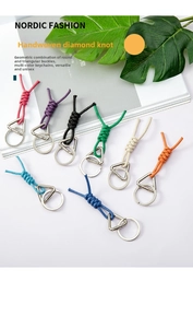 Close-up of handmade braided knot keychains in eight colors with dual metal rings