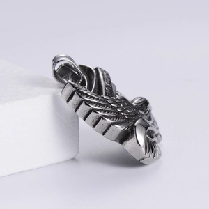 Detail of vintage silver eagle pendant with Live to Ride engraving on rock base