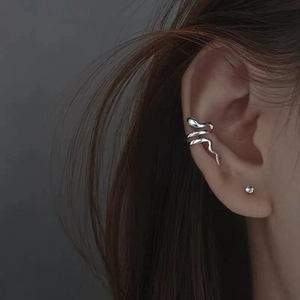 Silver snake-shaped ear cuff wrap for women featuring detailed serpent texture and metal finish