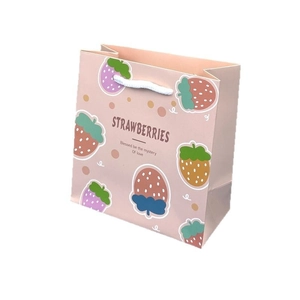 Pink DuPont paper gift bag with cute strawberry illustrations and white cotton handles