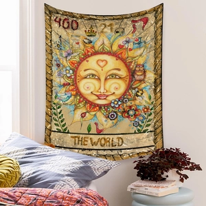 Close-up of bohemian The World tarot tapestry with sun and nature art on bedroom wall