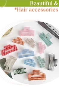 Collection of colorful checkered acrylic hair claws on a clean aesthetic background