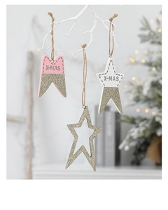 Detailed shot of pink and white Xmas star ornaments with glitter on a white branch