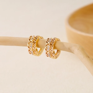 Detailed macro view of 18K gold plated hoop earrings with cubic zirconia and hollow design