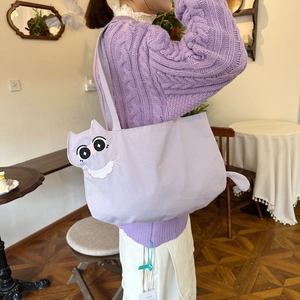 Detail of cute cat face embroidery on premium light purple canvas tote bag for women