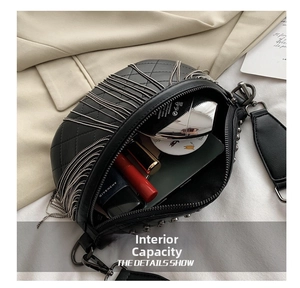 Detail view of large capacity black quilted leather bag with silver fringe and metal rivets