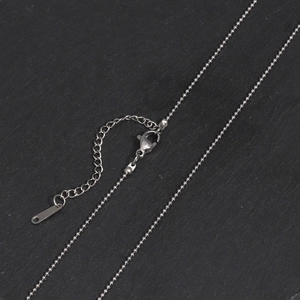 Detail of silver stainless steel ball chain featuring a lobster clasp and extension link
