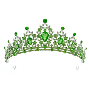 Macro detail of emerald green rhinestones set in a silver vintage bridal crown