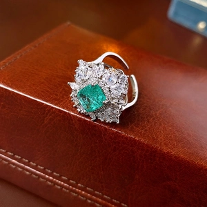Elegant adjustable ring with green square zircon and cluster of sparkling crystals