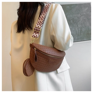 Detail of brown woven texture crossbody bag with coin purse and printed strap