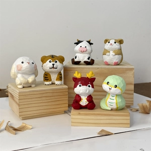Detailed view of hand-carved wooden zodiac animals with faceted textures and vibrant colors