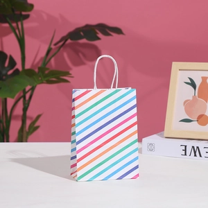 Colorful striped paper gift bag with white handles for parties and shopping needs