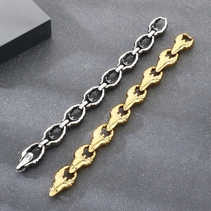 Detailed view of punk style bird skull link bracelets in gold and antique silver finishes