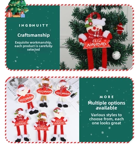 Detail of plush Christmas hanging dolls with Snowman and Reindeer on Feliz Navidad signs