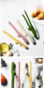 Detailed view of colorful silicone kitchen tongs for cooking with non-slip grip on marble