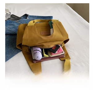 Internal view of the yellow canvas tote bag showing high capacity for daily essentials