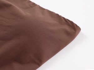 Close-up of soft dark brown ribbed knit fabric showing detailed texture and high elasticity