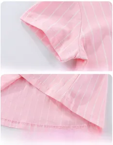 Close-up of pink striped cotton dress featuring detailed stitching on cuffs and hem