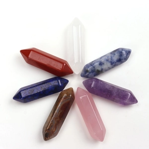 Macro display of seven colorful hexagonal crystal wands in a radial arrangement
