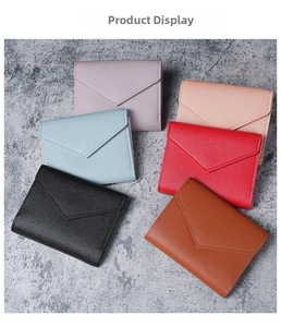 Detail view of colorful faux leather envelope wallets in various pastel shades