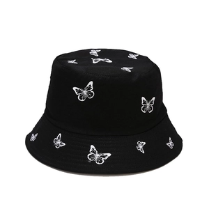 Reversible black cotton bucket hat with white butterfly embroidery for sun protection