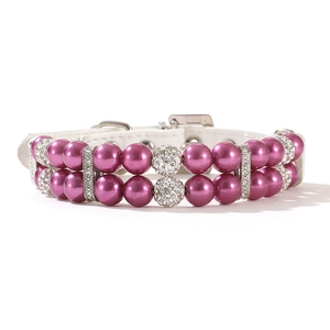 Detail of a luxury pet collar featuring double-row purple pearls and rhinestone accents